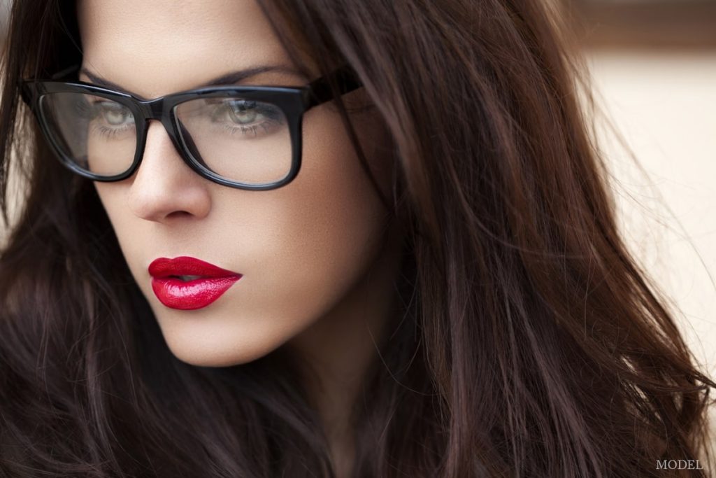 Woman wearing glasses and a bold red lip (MODEL)