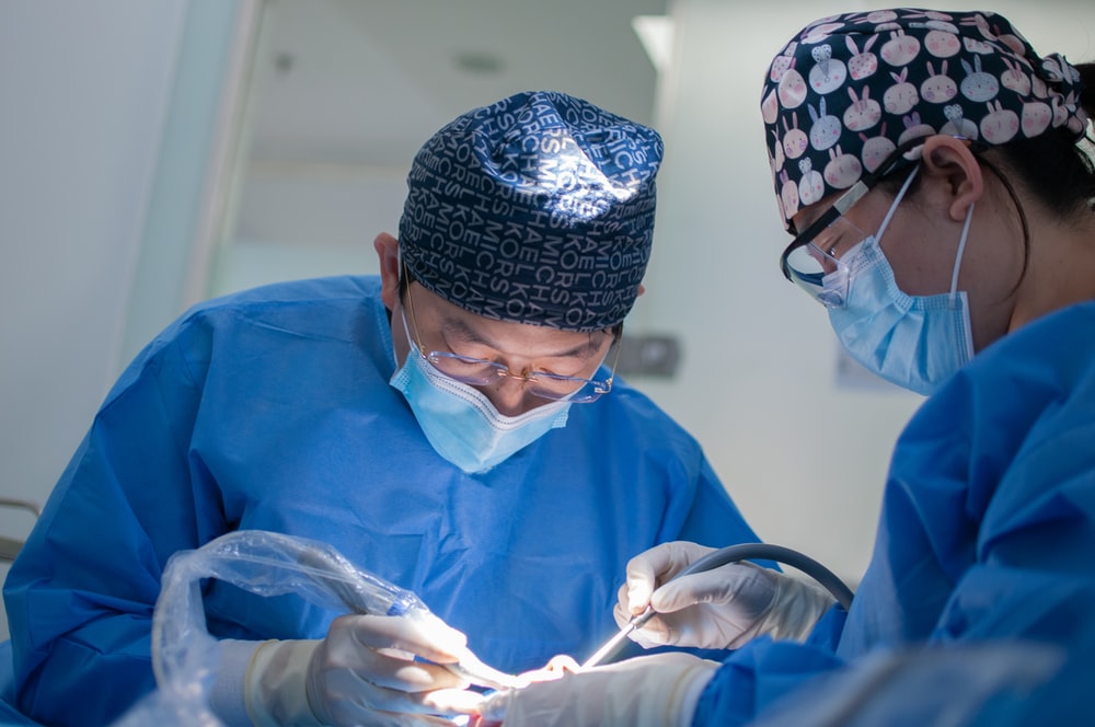 Doctor and assistant performing surgery.